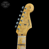 Close-up of a Fender guitar headstock on a black background with 'Tone Shop' logo.