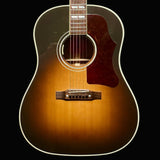 Acoustic guitar with a sunburst finish on a dark background