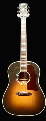 Acoustic guitar with a sunburst finish on a gray background