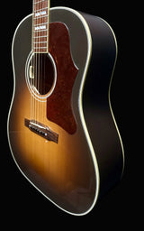 Acoustic guitar with a sunburst finish against a dark background