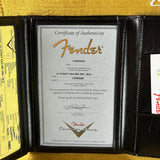Fender certificate of authenticity in a black leather holder with gold text.