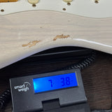 Fender Custom Shop Time Machine '57 Strat Heavy Relic Aged White Blonde on scale displaying weight.