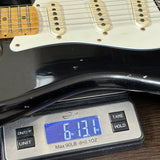 Guitar on a digital scale displaying weight