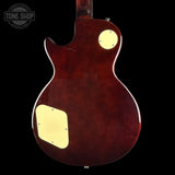 The back of an electric guitar with a glossy dark reddish-brown finish, featuring cream-colored pickguard and circular control knobs, shown against a black background with a Tone Shop watermark.