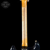 Close-up of a guitar neck with a black background, featuring the 'Tone Shop' logo.