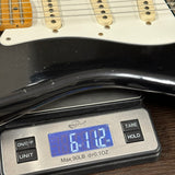 Guitar on a digital scale displaying weight
