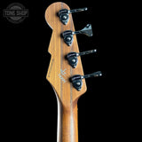 Wooden guitar headstock with tuning pegs on a black background, featuring 'Tone Shop' branding.
