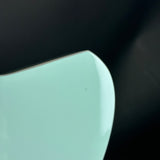Light blue ceramic plate on a black background
