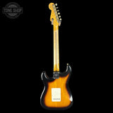 Electric guitar with a sunburst finish on a black background, featuring the Tone Shop logo.