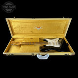 Fender guitar in a gold case with Fender logo on a black background