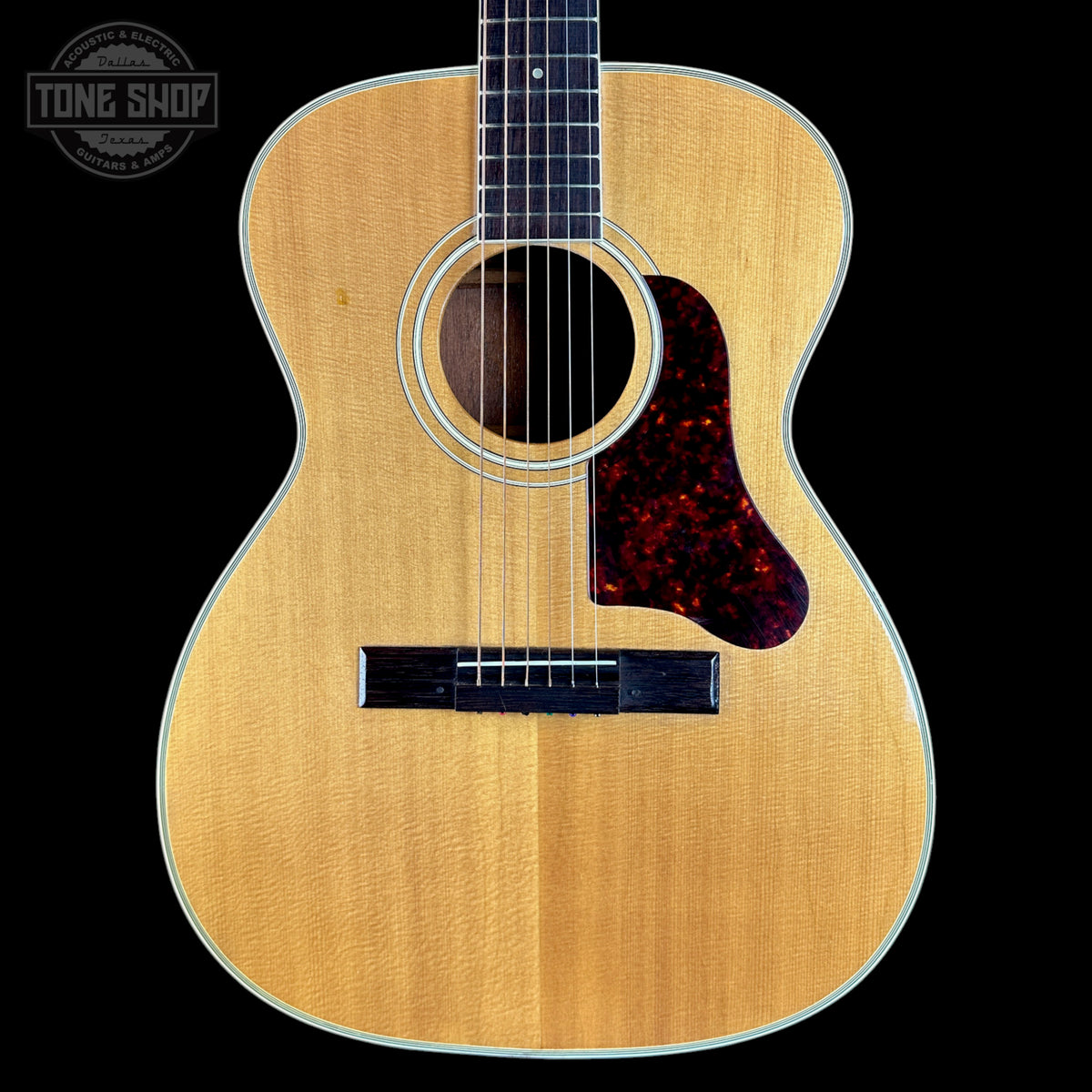 Acoustic guitar with a visible brand logo in the corner