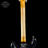 Guitar neck with a black pickguard on a black background, featuring the Tone Shop logo.