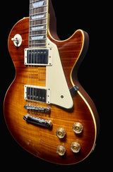 Electric guitar with a sunburst finish on a dark background