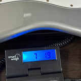 Used Squier Affinity Series Stratocaster Silver on scale displaying weight.