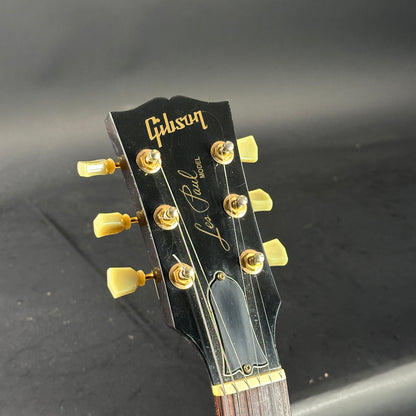 Gibson Les Paul guitar headstock on a dark background
