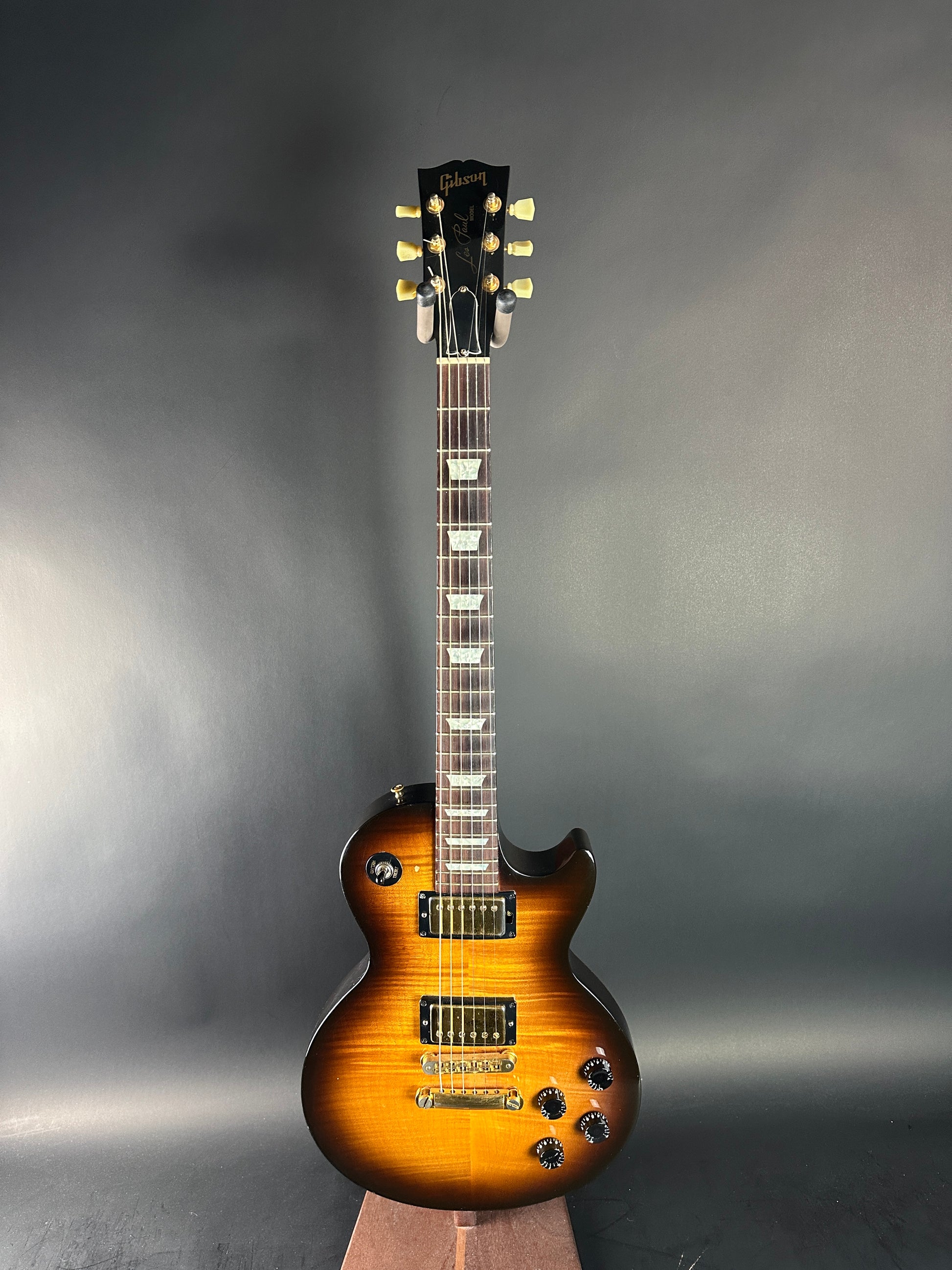 Electric guitar with a sunburst finish on a gray background