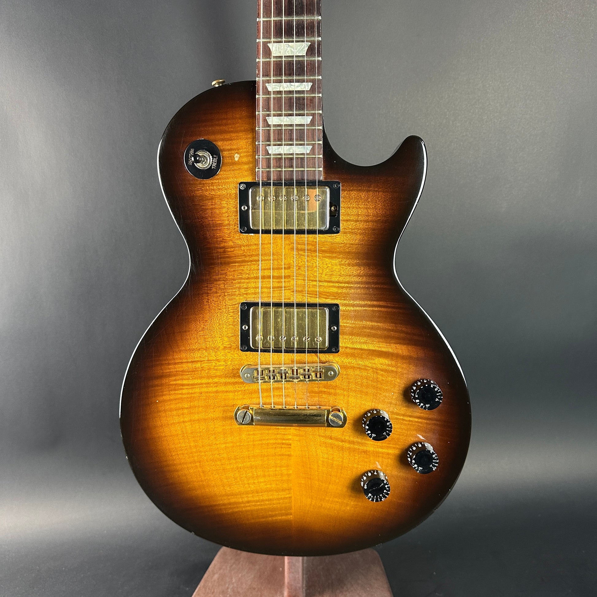 Electric guitar with a sunburst finish on a gray background
