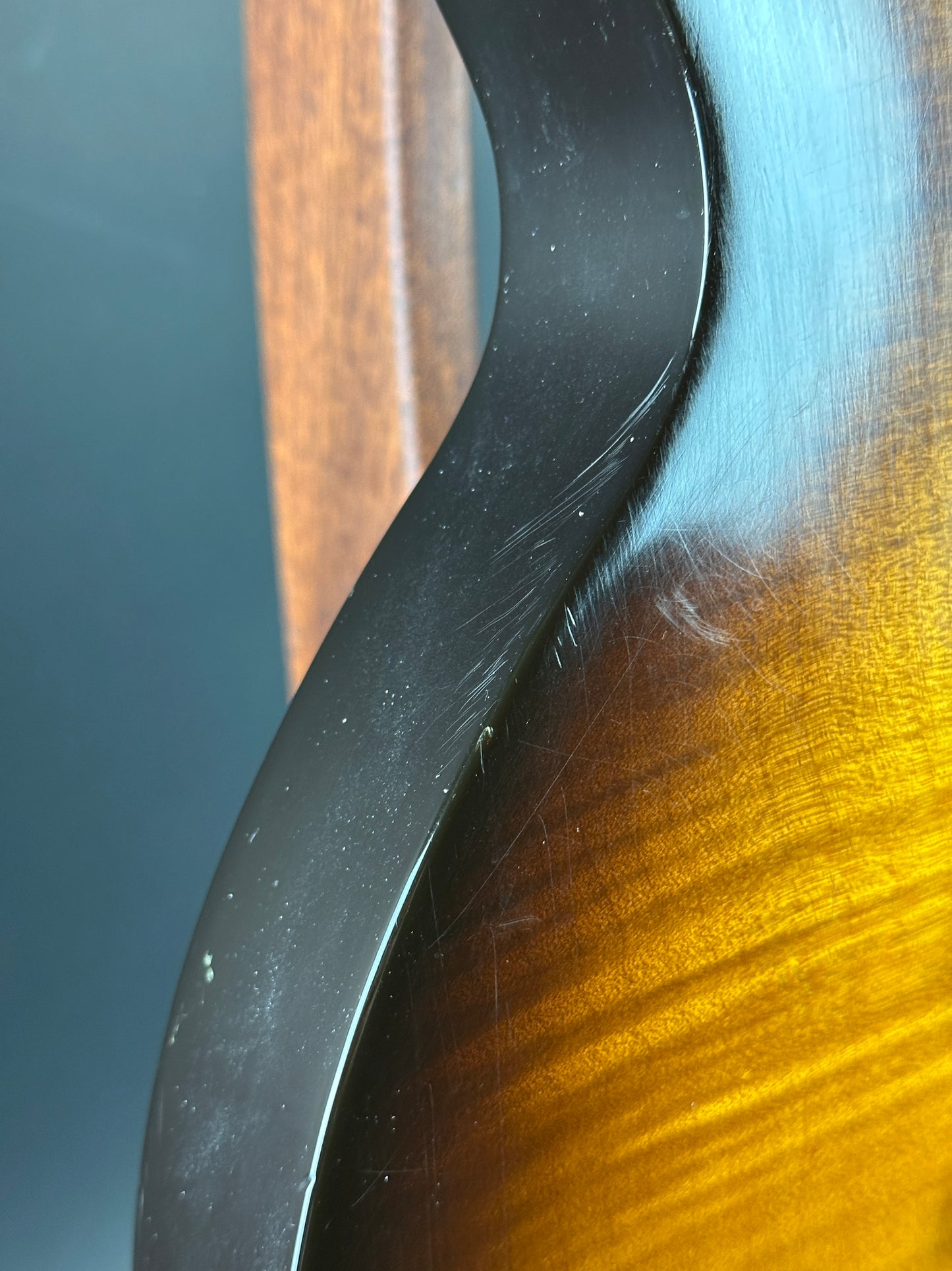 Close-up of a guitar neck with a focus on the wood grain and finish.