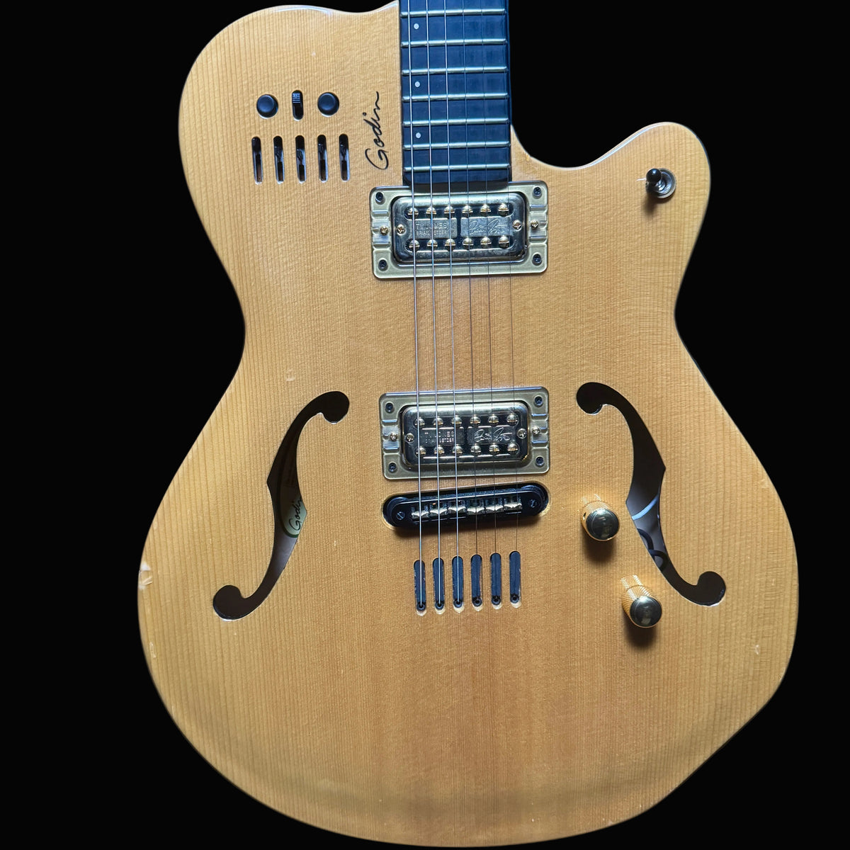Electric guitar with a wooden body on a dark blue background
