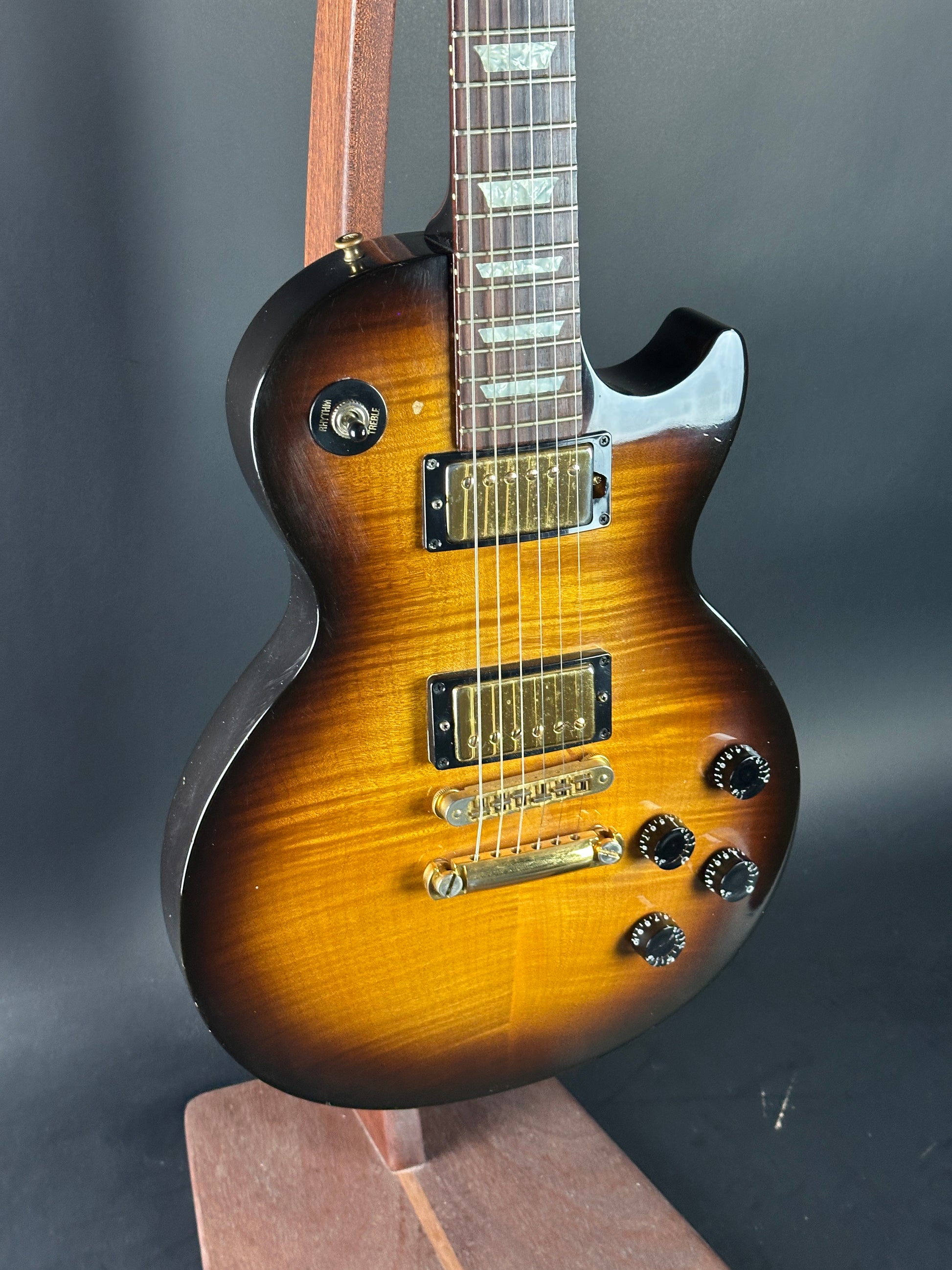 Electric guitar with a sunburst finish on a dark background
