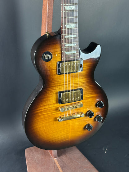 Electric guitar with a sunburst finish on a dark background