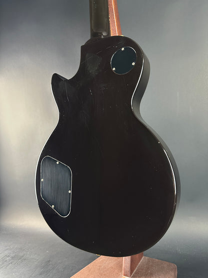 Black electric guitar body on a reflective surface