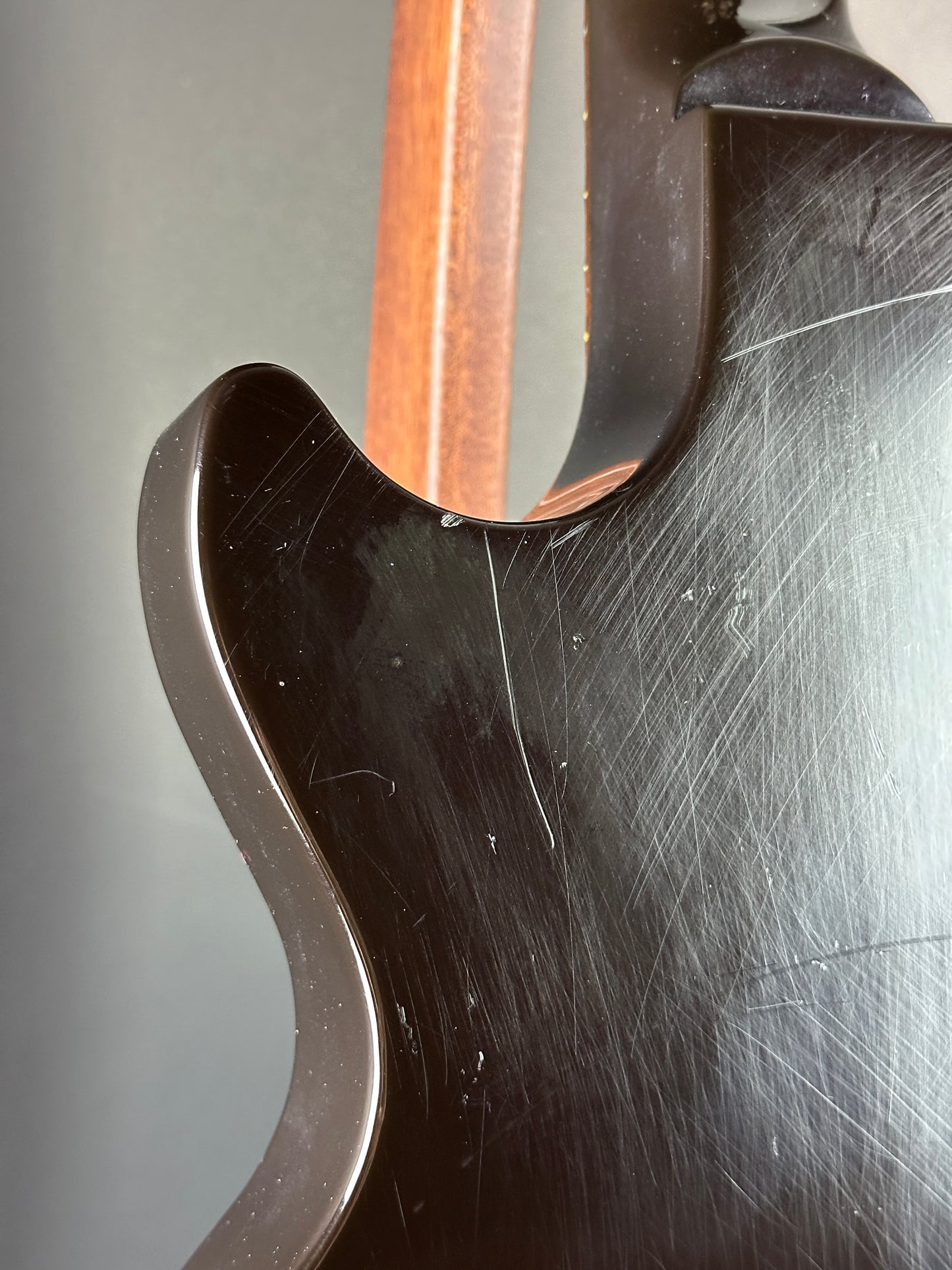 Close-up of a guitar's neck and headstock with a focus on the joinery.
