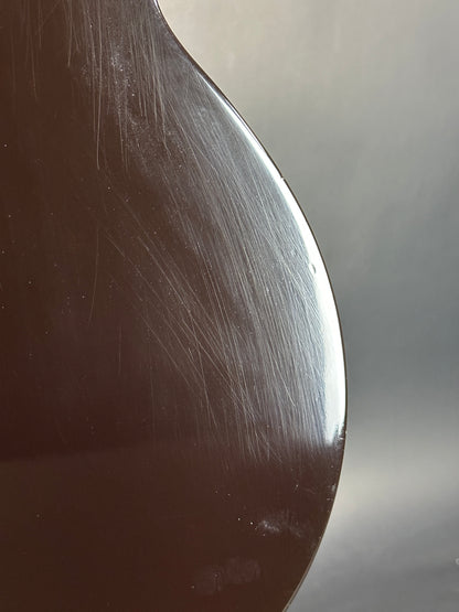 Close-up of a metal spoon with visible scratches on a reflective surface