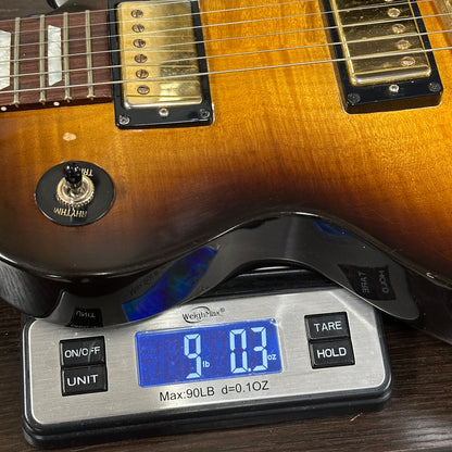 Guitar on a digital scale displaying weight