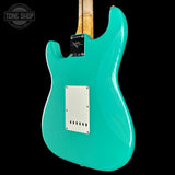 Turquoise electric guitar with a clear background