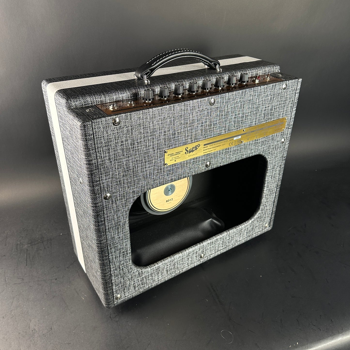 Guitar amplifier with a textured gray finish on a dark background