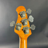 Close-up of a guitar's tuning pegs on a gray background