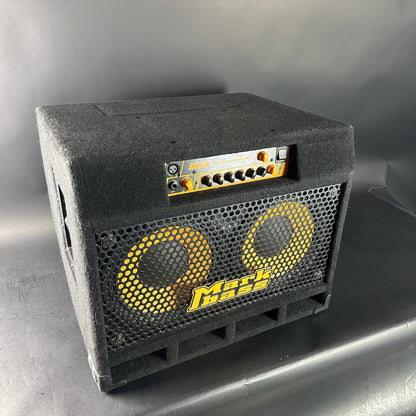 Black guitar amplifier with yellow text on a gray background