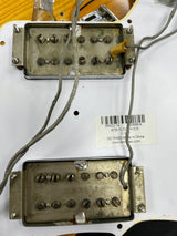 Guitar pickup with visible wiring on a white background