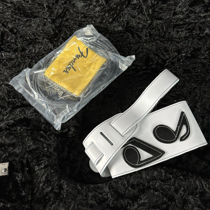 White belt with black logo and yellow cloth on a dark textured background