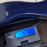 Used 1991 Fender American Standard Midnight Blue on scale displaying weight.