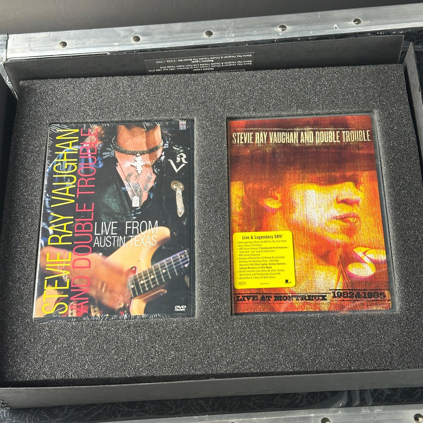 Stevie Ray Vaughan and Double Trouble album covers in a protective case.