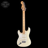 A classic Fender Stratocaster electric guitar with a cream finish, maple neck, and gold hardware, shown against a solid black background with a Tone Shop logo in the top-left corner.