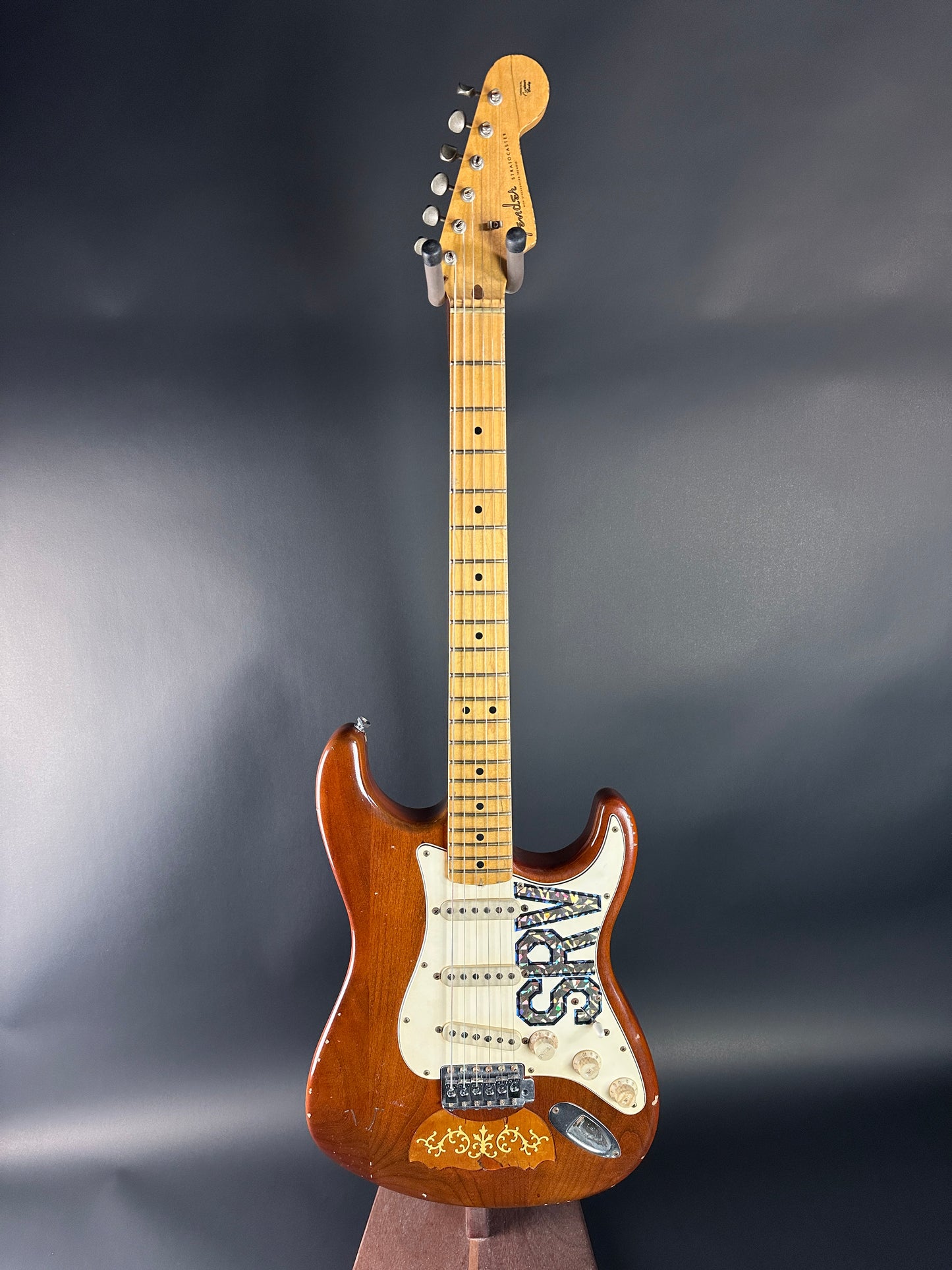 Electric guitar with a visible brand logo on a dark background