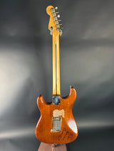 Wooden electric guitar on a gray background
