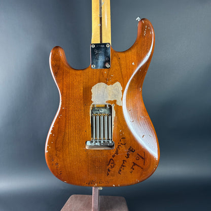 Vintage electric guitar with a worn finish on a gray background