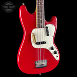 A red electric bass guitar with a white pickguard, shown from the side against a black background. The brand logo 'TONE SHOP' is visible in the top-left corner.