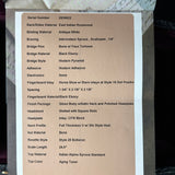 Technical specifications of a guitar displayed on a cardboard sheet.