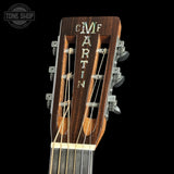 Close-up of a Martin guitar headstock with 'Tone Shop' logo in the corner.