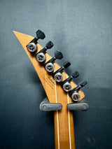 Guitar headstock with tuning pegs on a dark gray background