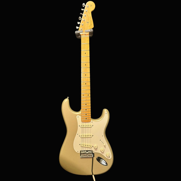 Beige electric guitar against a black background