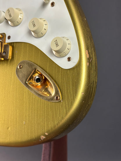 Close-up of a vintage electronic device with gold and white components.