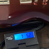 Used Epiphone Futura SG Custom Midnight Ember Shift on scale displaying weight.