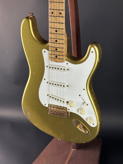 Gold electric guitar on a dark gray background