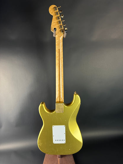Gold electric guitar on a dark background